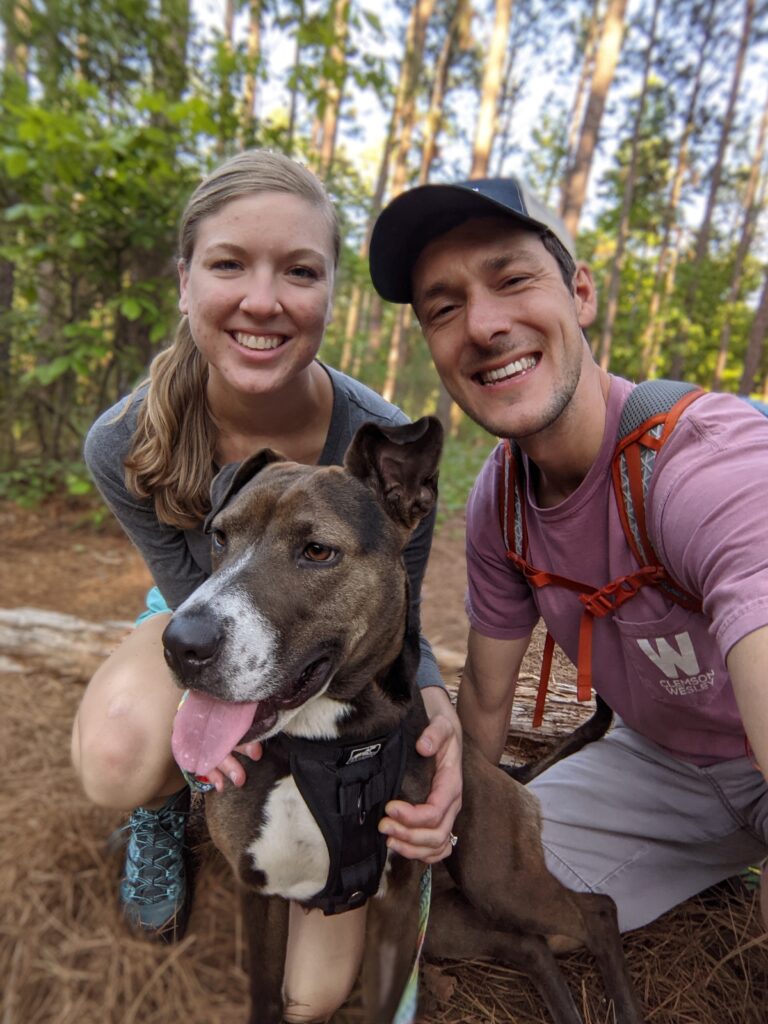 Erin, Jad, and their dog Rayna on a hike.
